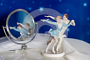 Figure skaters with reflection in a mirror