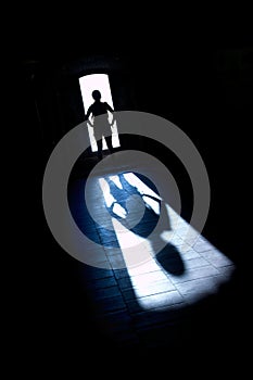 Figure standing in backlight