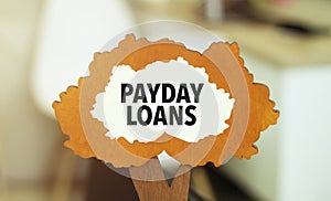 figure of a tree with text payday loans inside the foliage. Business concept financial tables with a pen