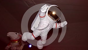 Figure of white astronaut suspend in air. Indoor. doll