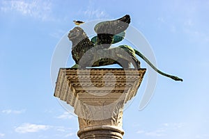 The figure of a winged lion on top of a pillar in Piazza San Marco in Venice, Italy