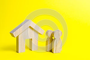 Figures of the family and house on a yellow background. real estate, your own home. Buying or selling. Affordable housing