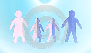 Figures of family people of father, mother and children on a blue background. Human genetics and genotype concept photo