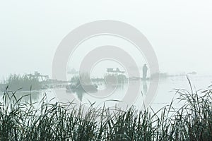 Figures of the fishermen in the fog