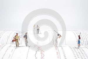 a  figures of golfers playing a golf at the open book