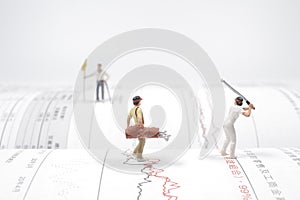a  figures of golfers playing a golf at the open book