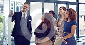 These figures look really good. a group of businesspeople working on a whiteboard in the boardroom.