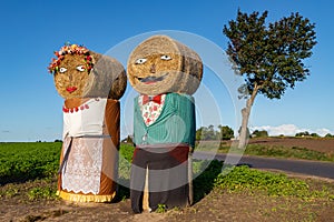 Figures made of sheaves of hay in the field. Ornaments in the countryside prisons