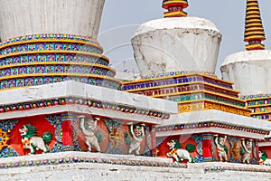 Figures and painting on a Tibetan stupa at the impressive Ta\'er Monastery near Xining, China