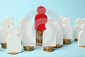 Figures of people on stacks of coins. Different levels of people`s earnings, pension growth