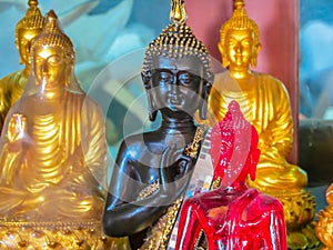 Figures of the sitting Buddha in the Wat Saket Temple or Golden mount, Bangkok, Thailand