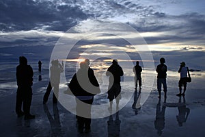 Figures at sunset on the Bolivian saltflats