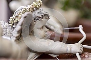 Figurine of amor aiming with bow and arrow photo