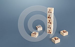 Figurine block tower with people. Hierarchical system. Company organization. Hiring, recruiting. Team building personnel