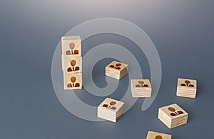 Figurine block tower with people. Hierarchical system. Company organization. Hiring, recruiting. Team building personnel