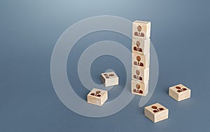 Figurine block tower with people. Hierarchical system. Company organization. Hiring, recruiting. Team building personnel photo