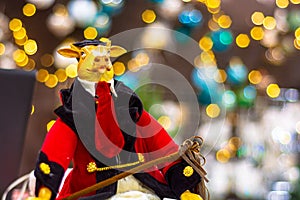 Figurine of a bull in a red velor suit and tie