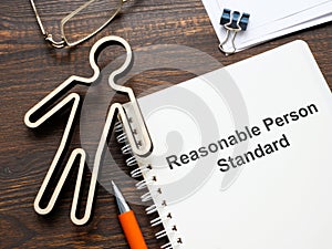 Figurine and document about Reasonable person standard. photo