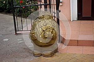 figurine of a fabulous bronze cat at the porch on the sidewalk in Zelenogradsk