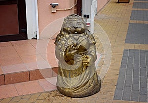 figurine of a fabulous bronze cat at the porch on the sidewalk in Zelenogradsk