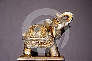 Figurine of golden dragon on white background