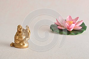 Figurine of a laughing and cheerful golden Buddha