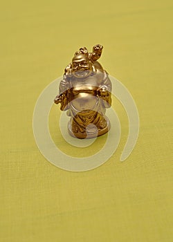 Figurine of a laughing and cheerful golden Buddha