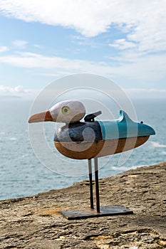 Figurine of seagull on the wall of the fortress in Nazare close up