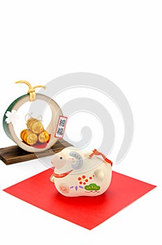 Figurine of Sheep and Three golden straw rice bags.