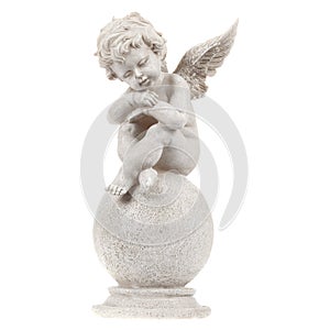 A figurine of a tired little angel from a gypsum resting on a round stone. On isolated white background