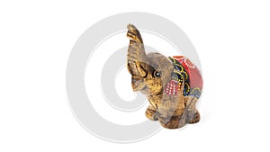 Figurine of a wooden elephant with pattern on the back isolated on white background. Decorative figurine of an elephant