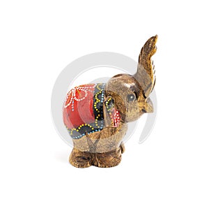 Figurine of a wooden elephant with pattern on the back isolated on white background. Decorative figurine of an elephant