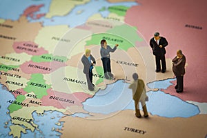 Figurines standing on the europe map around the azov and black sea photo