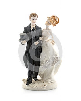 Figurines of a wedding cake on a white background.