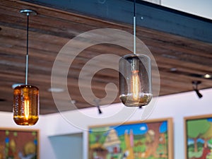 Filament light bulbs hanging high on wooden ceiling inside building