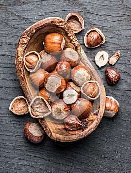 Filberts or hazelnuts in the wooden bowl on the table.