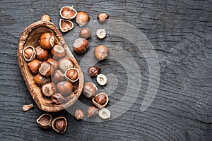 Filberts or hazelnuts in the wooden bowl on the table.