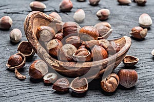 Filberts or hazelnuts in the wooden bowl on the table