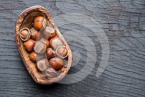 Filberts or hazelnuts in the wooden bowl on the table