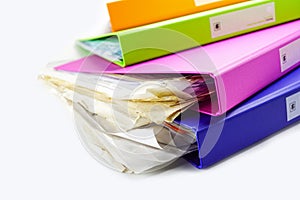 File Folder Binder stack of multi color on table in office.