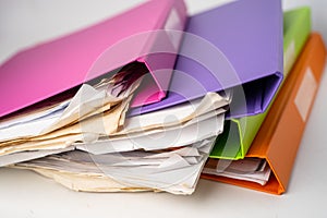 File Folder Binder stack of multi color on table.
