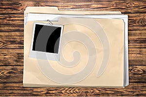 Yellow file folder on wooden background photo