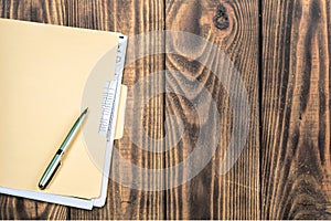 File Folder with pen on wooden background