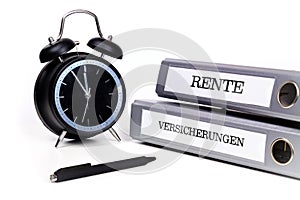 File folders and alarm clock symbolize time pressure. Translation: 