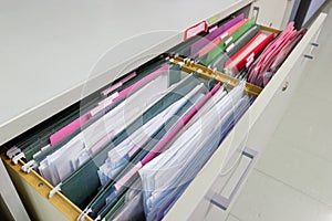 Files document of hanging file folders in a drawer in a whole pile
