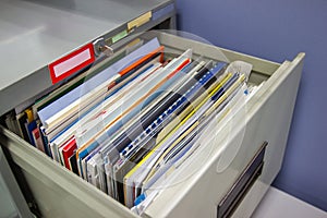 Files document of hanging file folders in a drawer in a whole pile