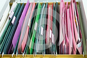 Files document of hanging file folders in a drawer in a whole pile of full papers