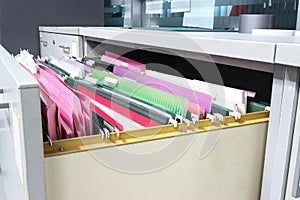 Files document of hanging file folders in a drawer in a whole pile of full papers, at work office