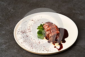 Filet mignon with mashed potatoes and pomegranate sauce, close-up