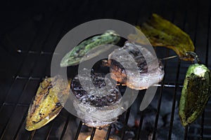 Filet Mignon and peppers roasting on an open flame barbque pit. photo